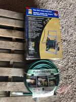 K38, NEW Power Fist hose reel trolly w/ shelf & NEW 100' garden hose, Holmes ceramic heater, (2) rodent Repellers