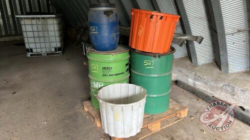 Pallet w/ (2) steel barrels ½ full of grass seed (stored for years), (2) poly tubs, (1) plastic barrel