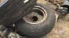 Pallet w/ Black and Decker angle grinder, (4) screw in bin anchors, Red metal toolbox (empty), (Used) Good Year 11L-15F1 imp tire, (Used) Good Year 9.5L-14 imp tire on 6 bolt rim - 4